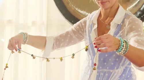 Woman Uses Garland with Bells Against Ride Cymbal in Studio