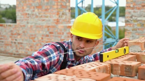Worker Control Brick Wall Using Level Tool