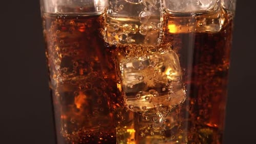 Refreshing Cola with Ice Close Up