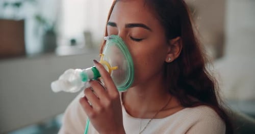 Young Woman Using Nebulizer Treatment at Home