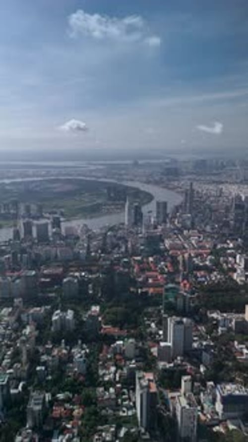Ho Chi Minh City, Vietnam view of CBD and river tilting down to top down view of Le Van Tam Park wit