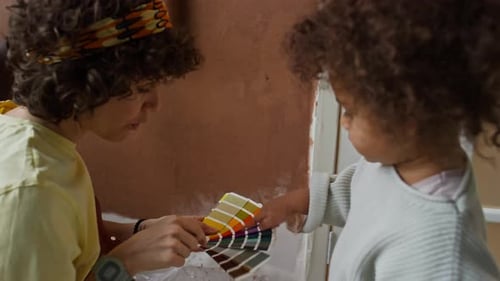 Adult and Child Reviewing Paint Colors Together