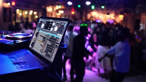 Dancing Crowd in Nightclub with Laptop and DJ Equipment