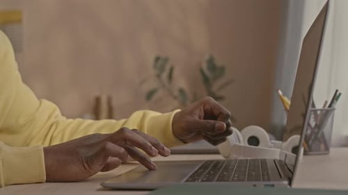 Hands Typing on a Laptop Computer at a Desk