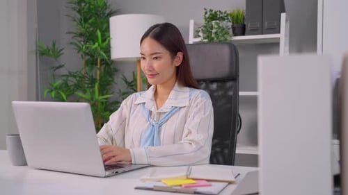 Asian beautiful businesswoman using laptop computer working in office.