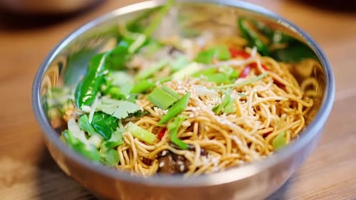 Close-up of noodles in bowl with fresh herbs
