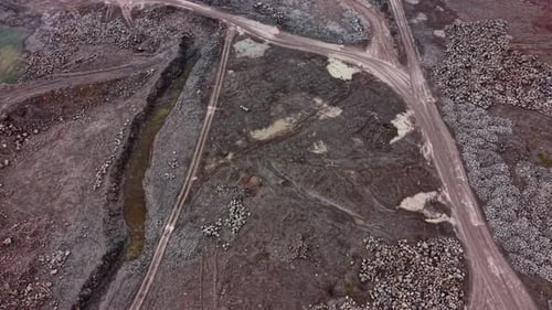 Granite quarry site with extraction paths and piles of stone