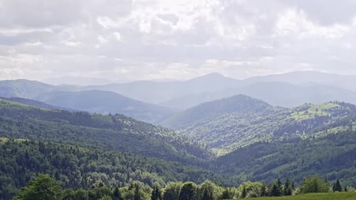 Rolling Green Hills and Mountainous Landscape