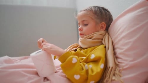 Sick Little Girl with Cold Blows Nose