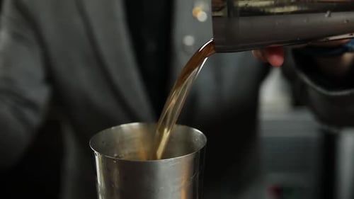 the bartender prepares a cocktail at the bar
