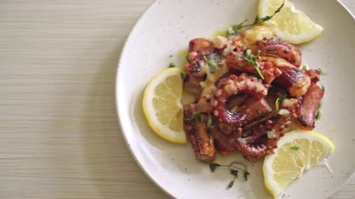 Grilled Octopus with Lemon and Thyme on Plate