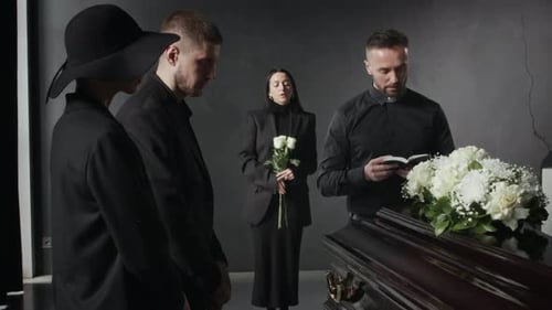 Adults Gathered Around Casket During Funeral Service
