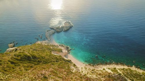 Aerial view of remote beach with turquoise sea and rocky outcrops in Cephalonia
