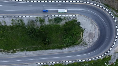 Top View of Car Truck Ride on Winding Road in Countryside Irrl