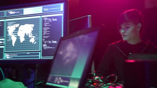 Young Adults Working at Computers in Dark Room