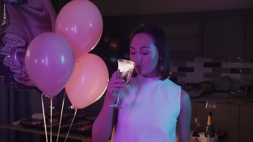 Home Masquerade Party Beautiful Adult Woman Drinking Champagne Standing at Balloons