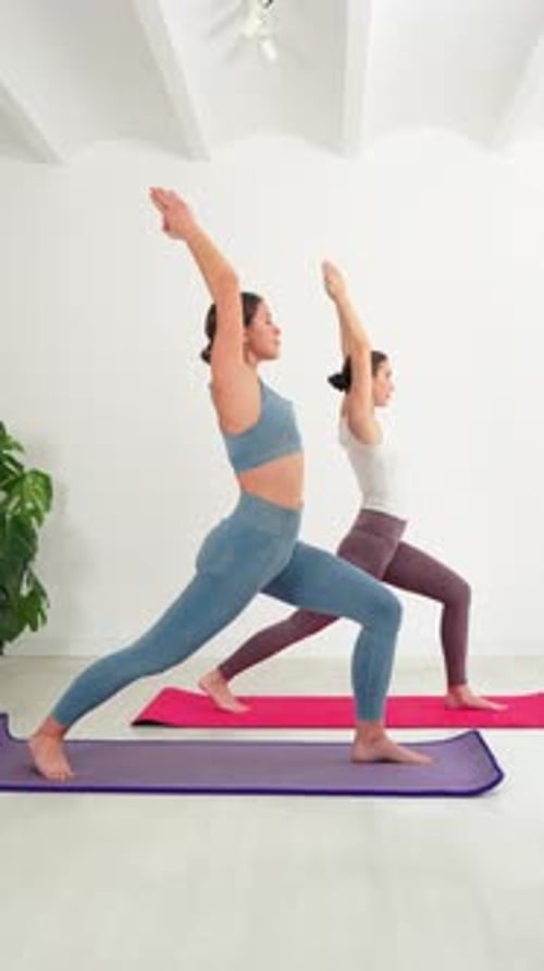 Women Doing Yoga in Bright Studio