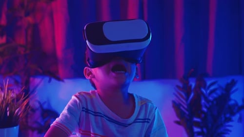 Boy Wearing VR Headset in Dark Room