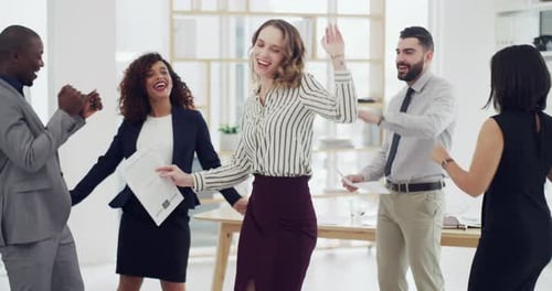 4k video footage of a group of businesspeople dancing together in an office