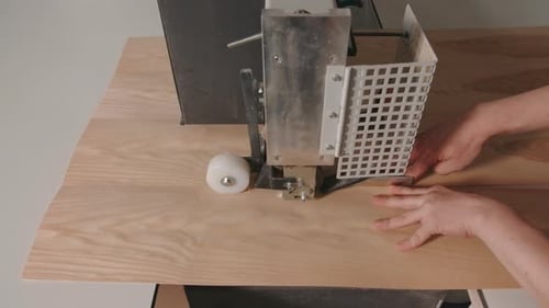 Close-up of worker cutting wooden board with machine. Creative. Homemade machine