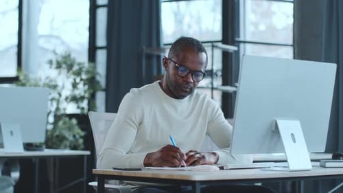 Man Working on Laptop at Desk