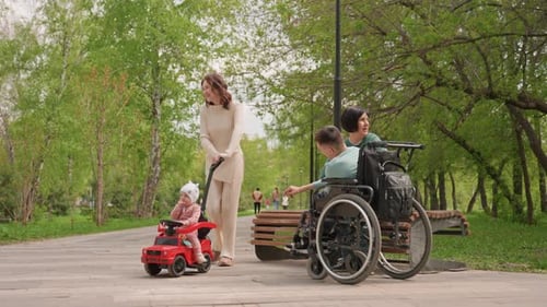 Family Resting Outdoors Park Scene With Young Family Caregivers Observe Child In Playful Setting