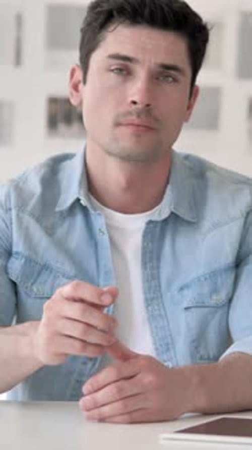 Denying Gesture by Businessman Sitting at Workplace, Vertical Video