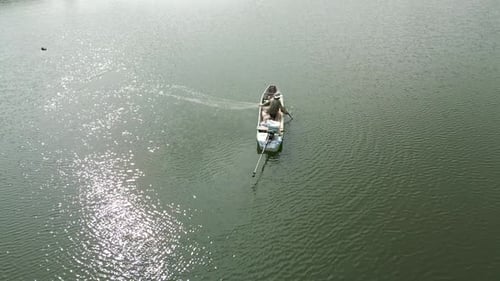Rural Fisherman Fishing From His Small Boat Spreading His Nets in Vietnam