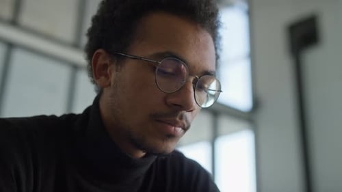Closeup of Focused Young Man Working on Laptop