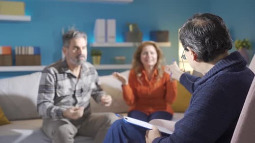 Psychiatrist listening to middle age couple.
