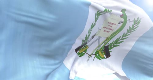 Realistic Waving Flag of Guatemala Against Blue Sky