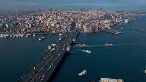 A Istanbul city with a bridge over a river and boats on the water