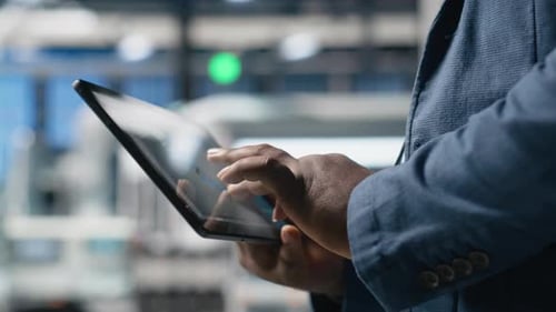 Industrial Specialist Checking Digital Manufacturing Systems on Tablet