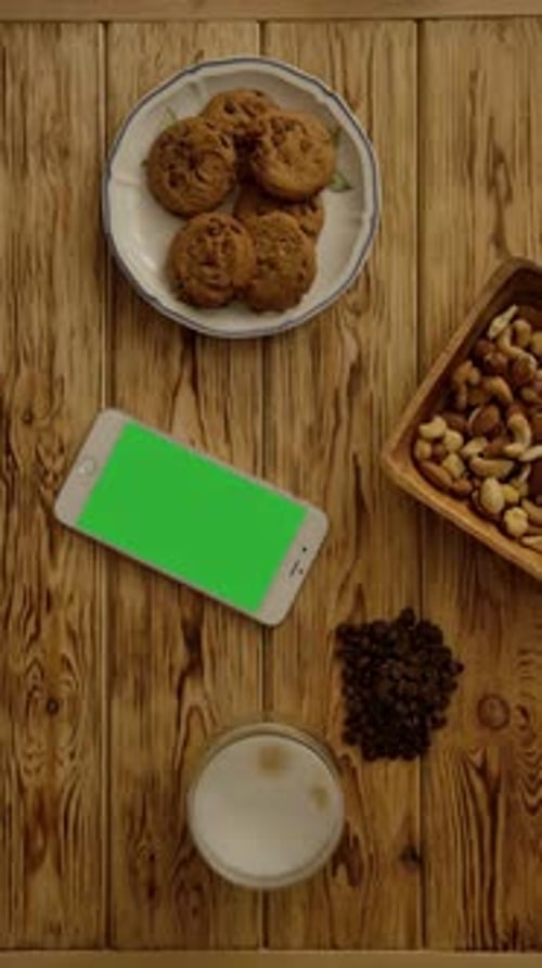 Phone with Green Screen Surrounded by Snacks