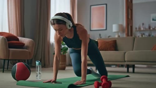 Woman Doing Yoga at Home on a Mat