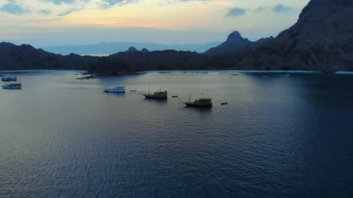 tourist ships at the coast of Padar Island, in Komodo National Park in Indonesia, captured from a dr