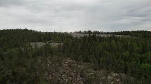 Drone View of Swedish Forest and Lake Landscape in the Summer, Rotating around Hill