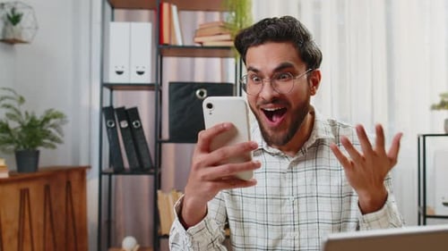 Man Using Mobile Phone for Video Call at Home