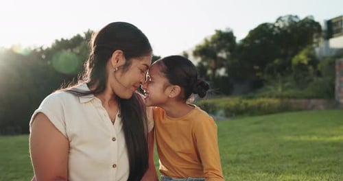 Mother and Daughter Embrace Outdoors in Warm Daylight