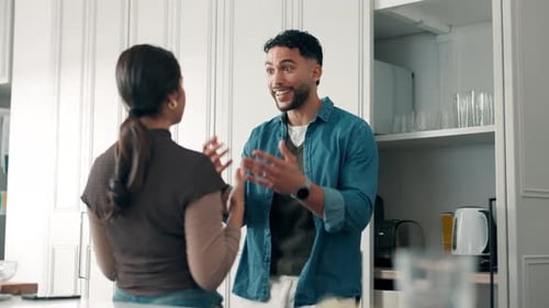 Couple Chatting and Smiling in a Bright Kitchen