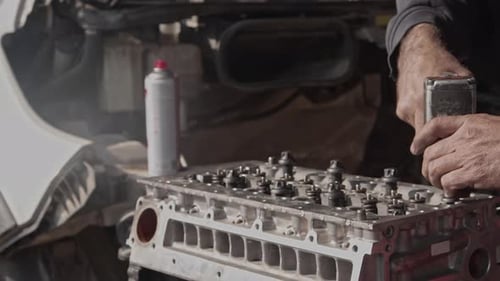 Mechanic Covers Valve Of Car Engine With Air Socket Wrench In Repair Shop