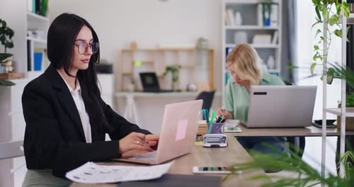 Team of Female Office Workers Working on Laptops