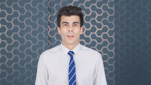 Confused office worker looking at camera.