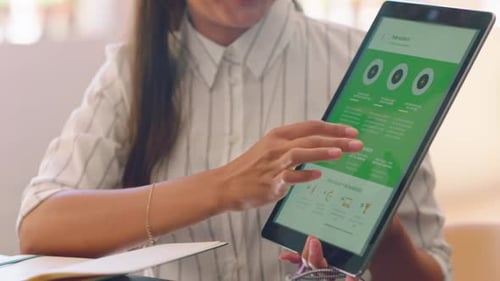 Woman Scrolls on Tablet in Workplace Office