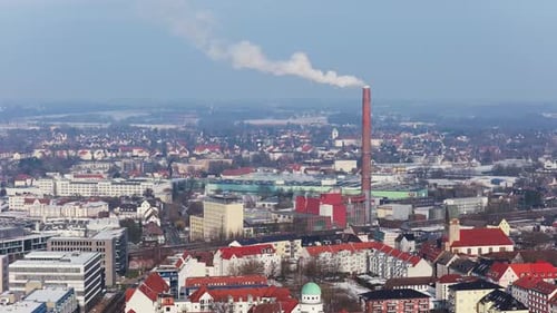 High Altitude Static Shot of Smoking Smokestack Polluting Air in Industrial Zone of the City of