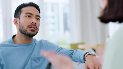 Man Talking and Gesturing During Indoor Conversation