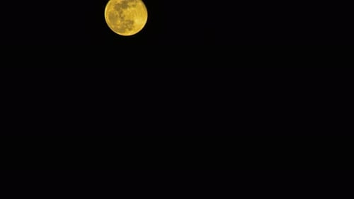 Full Moon Moving Slowly Across Dark Sky