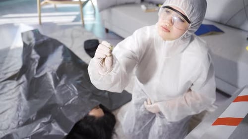 Forensic Investigator Examining Evidence at Crime Scene