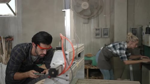 Carpenter are working at workshop.