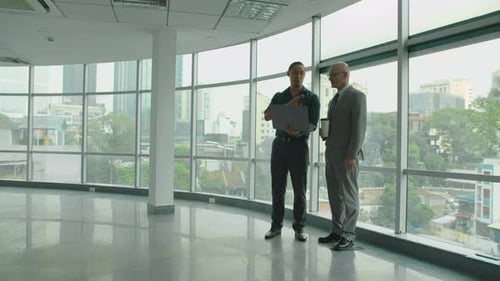 Businessmen Discussing Future Plans in Modern Urban Office